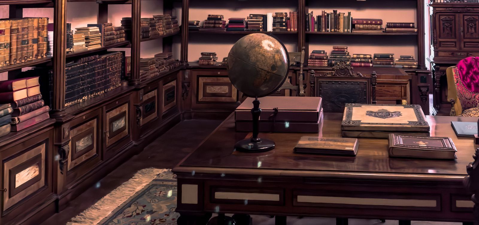 A private library with a globe on a long reading table