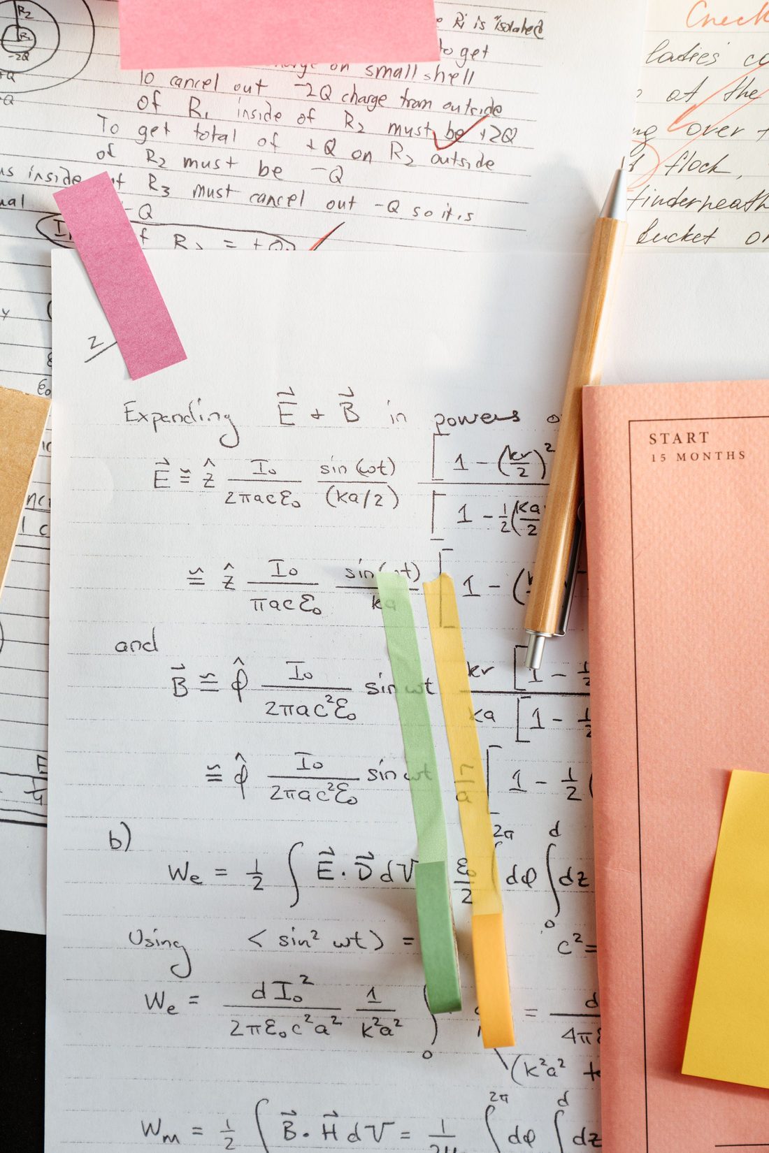 A student’s handwritten working, marked with sticky notes and highlighter tabs